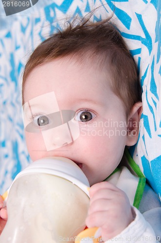 Image of Six-month girl drinks milk from a bottle