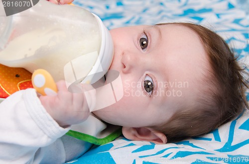 Image of Baby drinking milk from a bottle