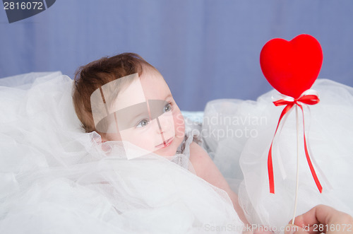 Image of Girl-baby in the crib give heart