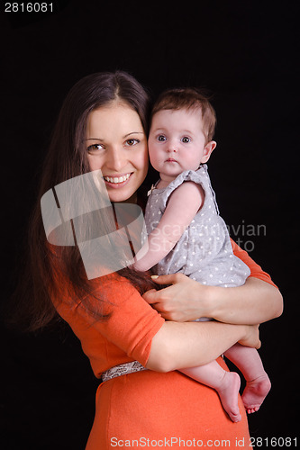 Image of Happy mother holding a baby