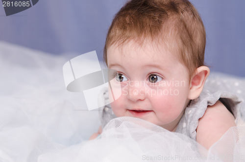 Image of Baby girl lying in crib