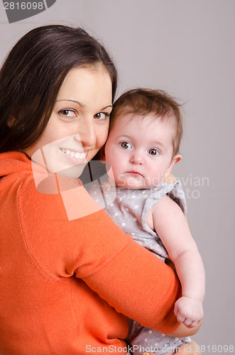 Image of Happy mother hugging her daughter