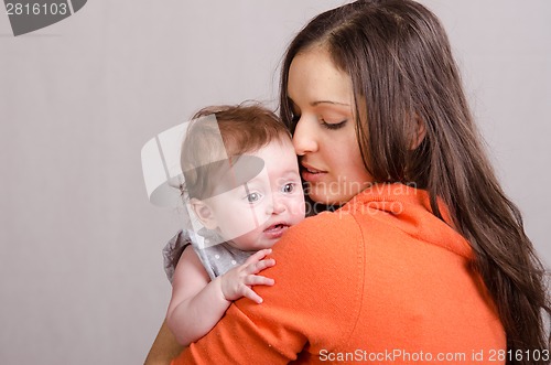 Image of Six-month baby girl on mother's hands