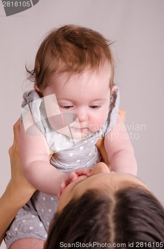 Image of Mom raised over a little girl