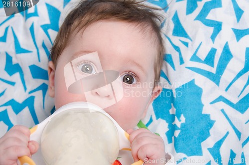 Image of Six-month girl drinking milk formula from a bottle