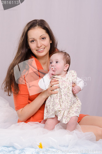 Image of Mom and daughter on the bed six-month