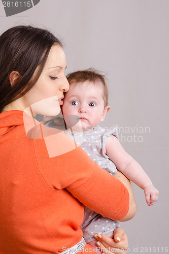 Image of Happy mother kissing her daughter