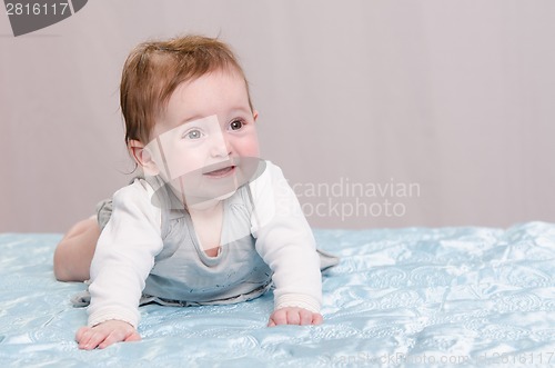 Image of Six-month girl learning to crawl
