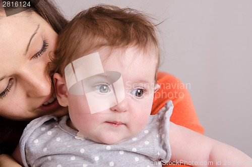 Image of Happy mother hugging her daughter