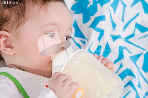 Image of Baby drinking milk formula from a bottle
