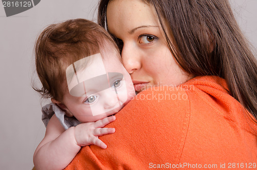 Image of Sad girl on hands happy mom