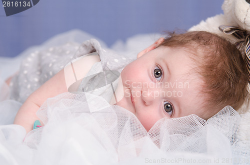 Image of Baby girl lying on a fabric