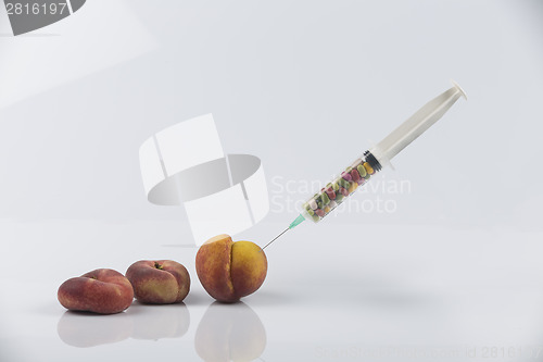 Image of Peaches and syringe with pills