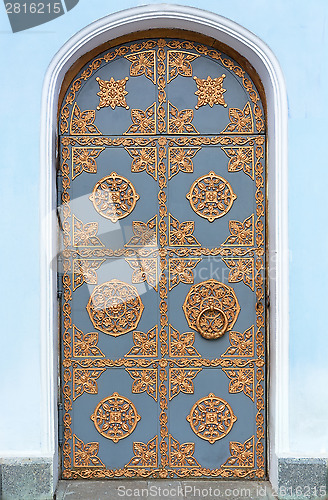 Image of Vintage door with wrought ornament.