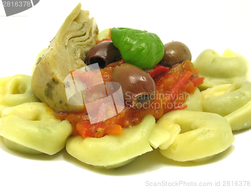 Image of Tortellini  with tomato sauce, leaf of basil, olives and artichoke