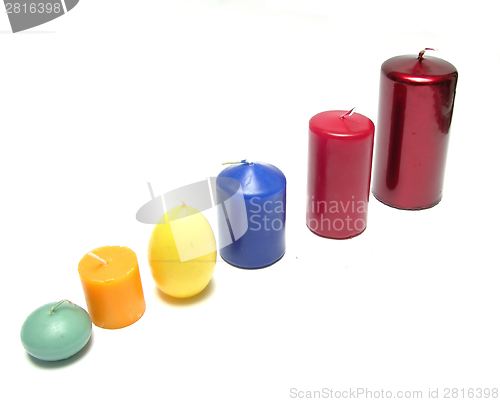 Image of Six different coloured candles in a line