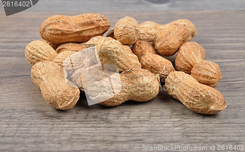 Image of Peanuts on wood