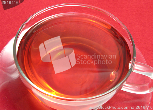 Image of Tea cup with rose hip tea on a placemat