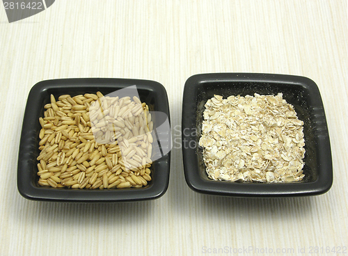 Image of Bowls of chinaware with oat and porridge on beige placemat