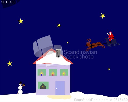 Image of Santa Claus riding on his reindeer sleigh over the top of a house