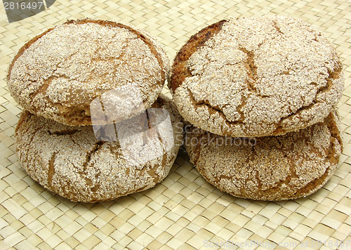 Image of Home made wholemeal vinschgauer buns on rattan underlay