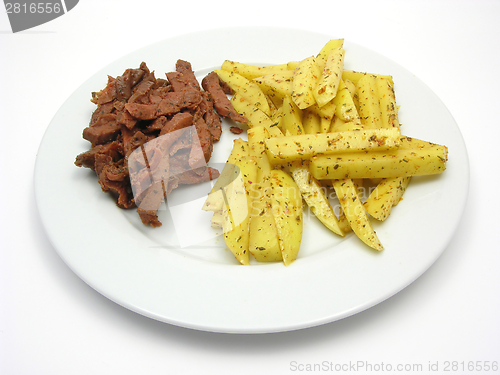 Image of Soy Geschnetzeltes and french fries on white plate