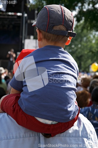 Image of Boy sitting on the shoulders of his father