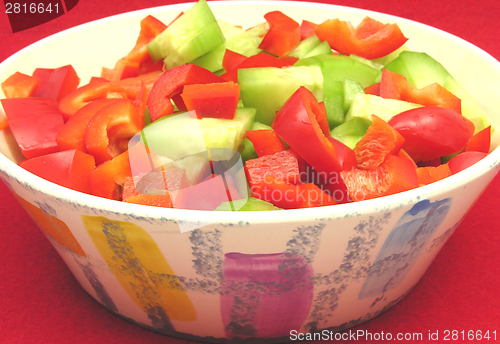 Image of Slices of cucumber and red pepper in a ceramics bowl 