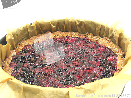 Image of Delicious berry cake in baking pan with baking paper