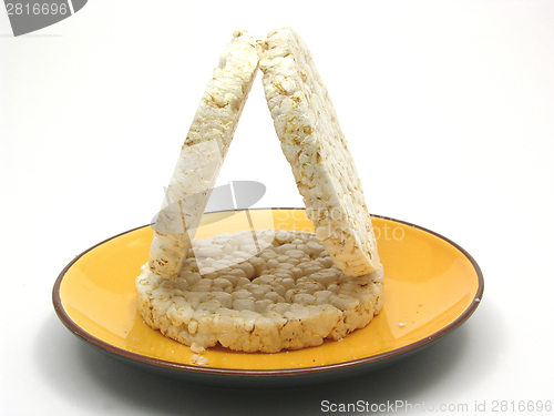 Image of Slices of puffed rice arranged on a bowl of ceramik on white