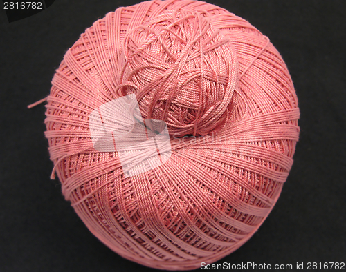 Image of Pink balls of wool  on a black background