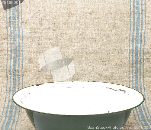 Image of Bowl of enamel on linen sheet