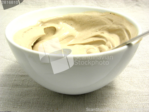 Image of Quark cheese mixed as dip in a bowl of chinaware on a placemat