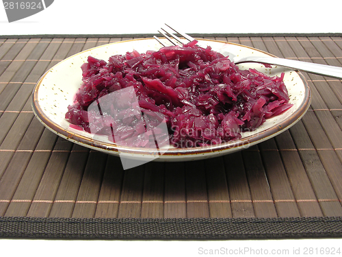 Image of Cooked red cabbage arranged on a plate with fork