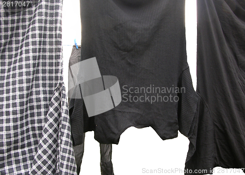 Image of Clothesline  with some laundered clothes on white