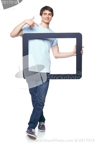 Image of Full length man holding tablet frame