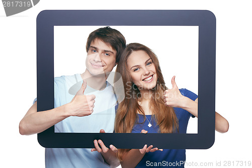 Image of Happy couple looking through tablet frame
