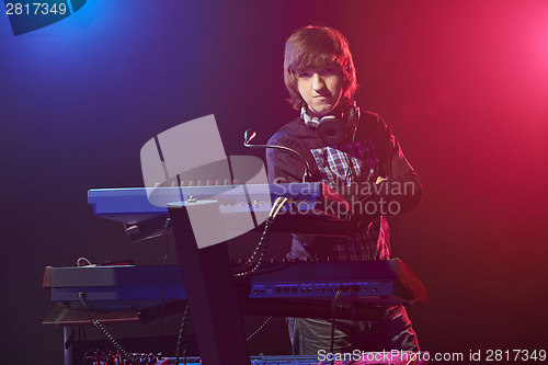 Image of Musician sitting on a keyboard