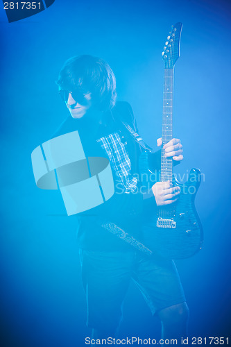 Image of Young guitarist performing on stage
