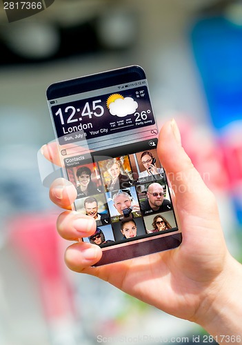 Image of Smartphone with transparent screen in human hands.