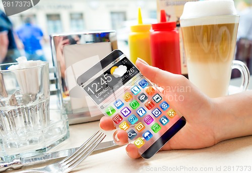 Image of Smartphone with transparent screen in human hands.