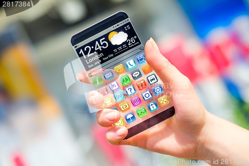 Image of Smartphone with transparent screen in human hands.