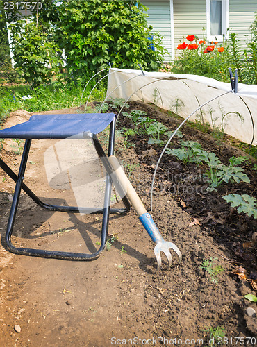 Image of Folding chair and rake