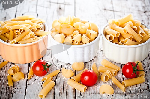Image of three bowls with uncooked pasta and cherry tomatoes