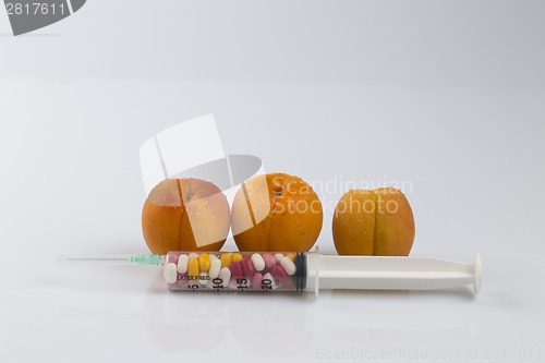 Image of Peaches and syringe with pills