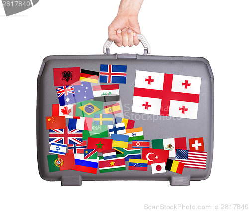 Image of Used plastic suitcase with stickers