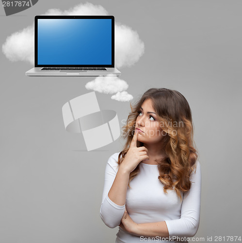 Image of Thinking woman and laptop on cloud
