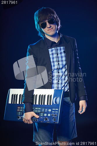 Image of Musician holding a keyboard