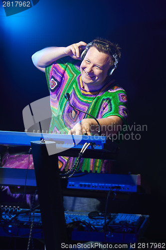 Image of Happy mid age musician playing on a keyboard