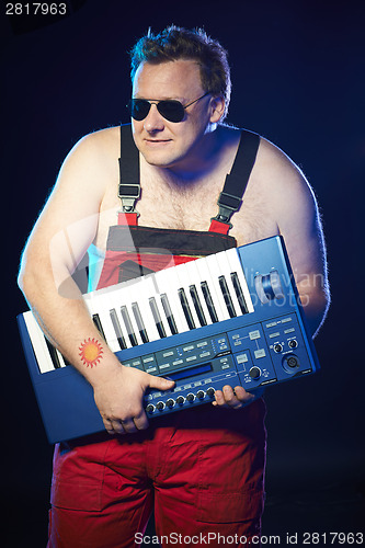 Image of Musician holding a keyboard